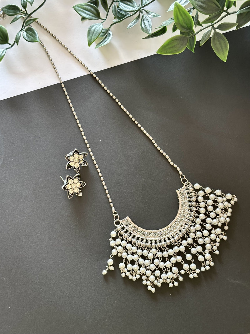 U-shaped pearl pendant set with long hanging pearls and floral stud earrings.